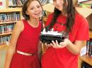 Anna Dautel, KI7WOJ (right), and Skyla Herman, KI7WPC, hold one of the 20-some rover prototypes. The rover is a dual-motor small tank chassis running off 6 V worth of AA batteries. Remote control of each rover is accomplished by using dual-tone multi-frequency signal tones from their radios.

 